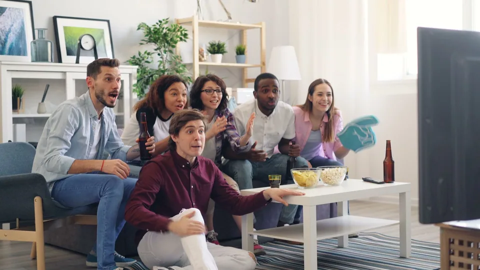 Friends enjoying live sports together with Honey Bee IPTV
